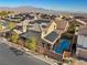 Beautiful aerial shot showcasing home with pool, solar panels, landscaped yard, and mountain views at 10729 Beecher Park Ave, Las Vegas, NV 89166
