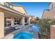 Backyard with a pool and spa combo, landscaped surroundings, and a covered patio area for outdoor entertaining at 10729 Beecher Park Ave, Las Vegas, NV 89166