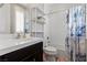This well-lit bathroom features a shower and tub combination with storage shelves and modern fixtures at 10729 Beecher Park Ave, Las Vegas, NV 89166
