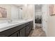 Bathroom featuring double sinks, modern cabinetry, and a shower-tub combo behind a decorative shower curtain at 10729 Beecher Park Ave, Las Vegas, NV 89166