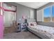 This stylish bedroom features a large window, carpet flooring, neutral décor, and an ensuite bathroom at 10729 Beecher Park Ave, Las Vegas, NV 89166
