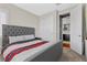 Comfortable bedroom with large bed, closet, and an open door to reveal a glimpse into a laundry room at 10729 Beecher Park Ave, Las Vegas, NV 89166