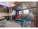 Bonus room/flex space with unique decor, tiered platform, and glass doors to kitchen at 10729 Beecher Park Ave, Las Vegas, NV 89166