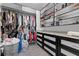 This walk-in closet features an abundance of space with custom built-in cabinets, shelves, and rods for storage at 10729 Beecher Park Ave, Las Vegas, NV 89166