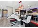 The dining area offers seating for six and is adjacent to the kitchen and grand staircase at 10729 Beecher Park Ave, Las Vegas, NV 89166