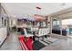 Open dining area with modern light fixture, seating for eight and sliding glass doors to the outdoor patio at 10729 Beecher Park Ave, Las Vegas, NV 89166