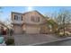 Charming two-story home with a three-car garage, stone accents, and a well-maintained front yard at 10729 Beecher Park Ave, Las Vegas, NV 89166