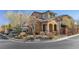 House's exterior features stone and stucco finishes, landscaping, and a street view at 10729 Beecher Park Ave, Las Vegas, NV 89166