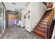 Inviting foyer featuring tile flooring and a staircase with wood treads and black metal railing at 10729 Beecher Park Ave, Las Vegas, NV 89166