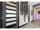 Elegant foyer with modern decor, a stylish front door, artistic wall accents, and tile flooring at 10729 Beecher Park Ave, Las Vegas, NV 89166