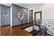 Upstairs hallway featuring wood floors, modern art and metal railings at 10729 Beecher Park Ave, Las Vegas, NV 89166