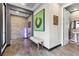 Entryway featuring stone accent wall, contemporary artwork, and easy access to a nearby bathroom at 10729 Beecher Park Ave, Las Vegas, NV 89166