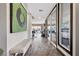 Bright hallway with a textured bench and large windows offering view to the backyard at 10729 Beecher Park Ave, Las Vegas, NV 89166