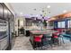 This kitchen has stainless steel appliances, a large granite island, and unique overhead lighting at 10729 Beecher Park Ave, Las Vegas, NV 89166