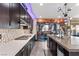 Modern kitchen featuring dark cabinets, an island, and stainless steel appliances at 10729 Beecher Park Ave, Las Vegas, NV 89166