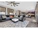 Open-concept living room with modern decor and seamless transition to the kitchen and dining area at 10729 Beecher Park Ave, Las Vegas, NV 89166