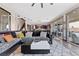 Open-concept living space featuring a large sectional sofa and sliding glass doors at 10729 Beecher Park Ave, Las Vegas, NV 89166