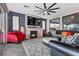 Living room with fireplace, TV, fan, and tile flooring at 10729 Beecher Park Ave, Las Vegas, NV 89166