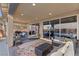 Inviting outdoor patio with ample seating, decorative rug, view of the pool, and seamless transition to the indoors at 10729 Beecher Park Ave, Las Vegas, NV 89166
