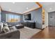 Comfortable recreation room with a sectional sofa, large windows, and a wall-mounted TV at 10729 Beecher Park Ave, Las Vegas, NV 89166