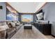 Spacious recreation room featuring a large sectional sofa and a wall-mounted TV at 10729 Beecher Park Ave, Las Vegas, NV 89166