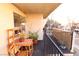 Balcony featuring a wooden table and chairs with railing overlooking a garden and mature trees at 1303 Darlene Way # 102B, Boulder City, NV 89005