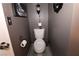 Clean and simple bathroom with toilet and dark-colored walls at 1303 Darlene Way # 102B, Boulder City, NV 89005