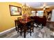 Cozy dining area with a dark wood table and chairs, and a chandelier at 1303 Darlene Way # 102B, Boulder City, NV 89005