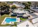 Aerial view of a luxury home with a large pool, outdoor lounge area, and well-manicured lawn at 1630 Westwood Dr, Las Vegas, NV 89102
