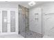 Beautiful bathroom featuring tiled walk-in shower with a glass partition and mosaic-tiled floor at 1630 Westwood Dr, Las Vegas, NV 89102