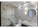Modern bathroom with marble walls, glass shower, and stylish gold hardware accents at 1630 Westwood Dr, Las Vegas, NV 89102