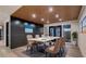 Contemporary dining room with a white table, seating for six, modern lighting, and dark paneled wall at 1630 Westwood Dr, Las Vegas, NV 89102