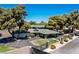 Modern home with lush landscaping, mature trees, and a circular driveway behind a secure fence at 1630 Westwood Dr, Las Vegas, NV 89102