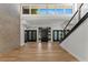 Bright foyer features soaring ceilings, beautiful wood floors, and brick accent wall at 1630 Westwood Dr, Las Vegas, NV 89102