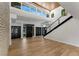 Open foyer with lots of natural light, high ceilings, wood floors, and staircase at 1630 Westwood Dr, Las Vegas, NV 89102