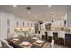 Spacious kitchen with white cabinets, modern appliances, an island, and dining area with seating at 1630 Westwood Dr, Las Vegas, NV 89102