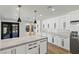 Modern kitchen featuring an island, sleek white cabinetry, stone countertops, and stainless steel appliances at 1630 Westwood Dr, Las Vegas, NV 89102