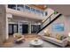 Bright living room with high ceilings, skylights, hardwood floors, and a view of the staircase at 1630 Westwood Dr, Las Vegas, NV 89102