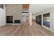 Open-concept living room with fireplace, light wood floors, and views of the backyard at 1630 Westwood Dr, Las Vegas, NV 89102