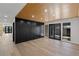 Spacious room featuring wood-paneled ceiling, accent wall, and wide-plank wood floors at 1630 Westwood Dr, Las Vegas, NV 89102