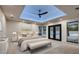 Serene main bedroom featuring a tray ceiling, ceiling fan, and doors leading to the outdoor spa and pool at 1630 Westwood Dr, Las Vegas, NV 89102