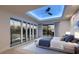Bright main bedroom with many large windows offering views of the outdoor spa, ceiling fan, and ensuite bath at 1630 Westwood Dr, Las Vegas, NV 89102