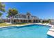 Luxury home with a sparkling pool, lounge chairs, spiral staircase, and expansive lawn at 1630 Westwood Dr, Las Vegas, NV 89102