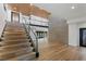 Staircase with wood steps, glass railing, and open view of main level at 1630 Westwood Dr, Las Vegas, NV 89102