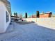 Back yard has covered patio, white gravel, and mature trees at 2600 Congress Ave, Las Vegas, NV 89121