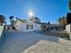 Backyard of a single-story home features an open patio space with a rock landscape and perimeter walls at 2600 Congress Ave, Las Vegas, NV 89121