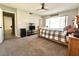 Spacious bedroom with a wooden bed frame, ceiling fan, and doorway leading to the rest of the house at 2600 Congress Ave, Las Vegas, NV 89121