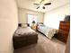 Shared bedroom features twin beds, soft carpet, and a ceiling fan for added comfort at 2600 Congress Ave, Las Vegas, NV 89121