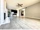 Open living room featuring a brick fireplace, tile floors, and a ceiling fan for added comfort and style at 2600 Congress Ave, Las Vegas, NV 89121