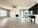 Spacious living room with a fireplace, ceiling fan, and sliding glass doors that flood the room with natural light at 2600 Congress Ave, Las Vegas, NV 89121